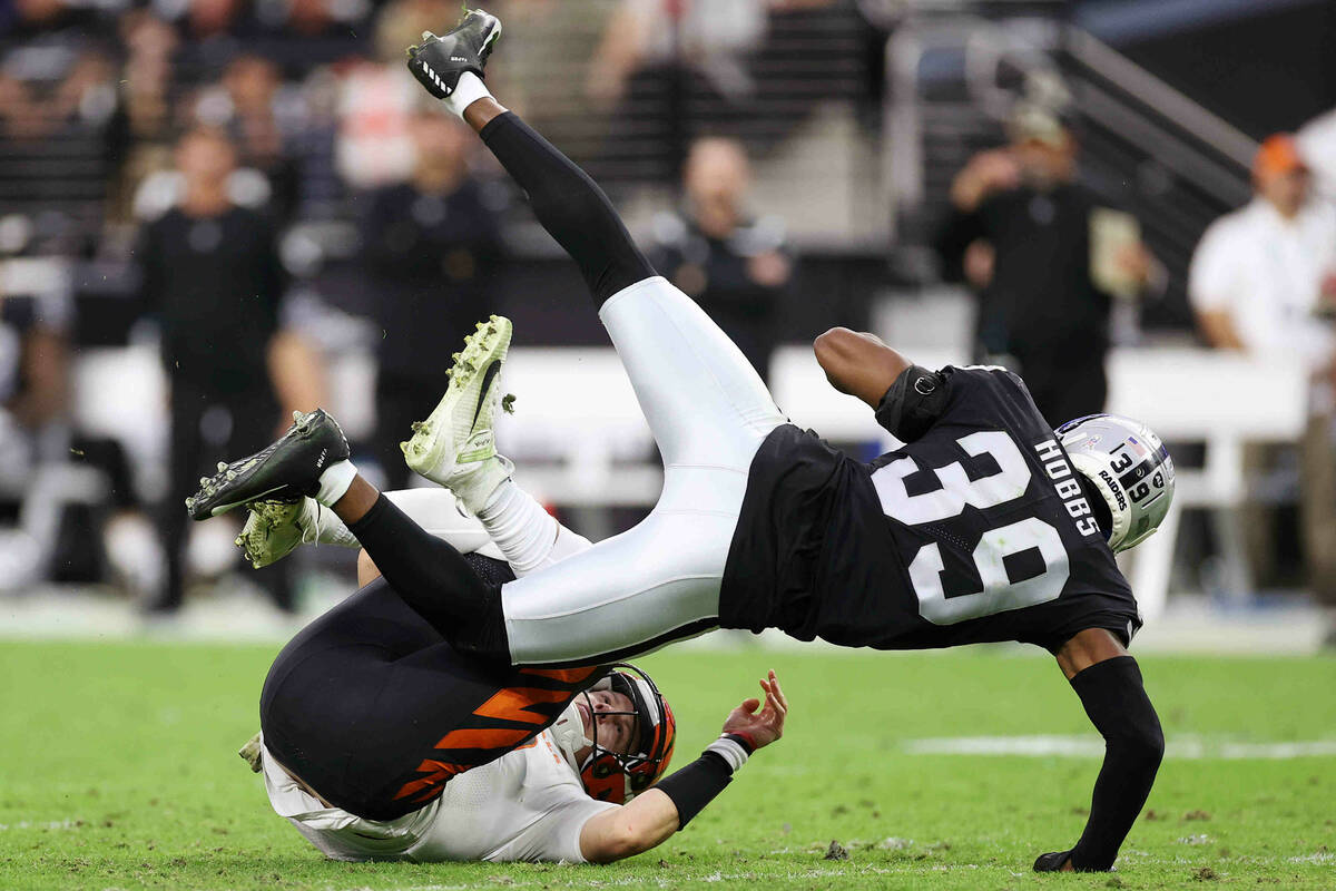 Raiders cornerback Nate Hobbs (39) tackles Cincinnati Bengals quarterback Joe Burrow (9) after ...