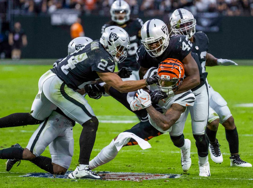 Cincinnati Bengals wide receiver Ja'Marr Chase (1) is stopped on a critical third down by Raide ...