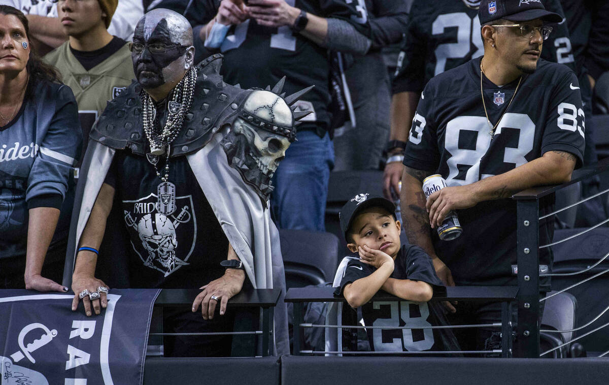 A young Raiders fan is dejected along with others in the stands as the Cincinnati Bengals have ...