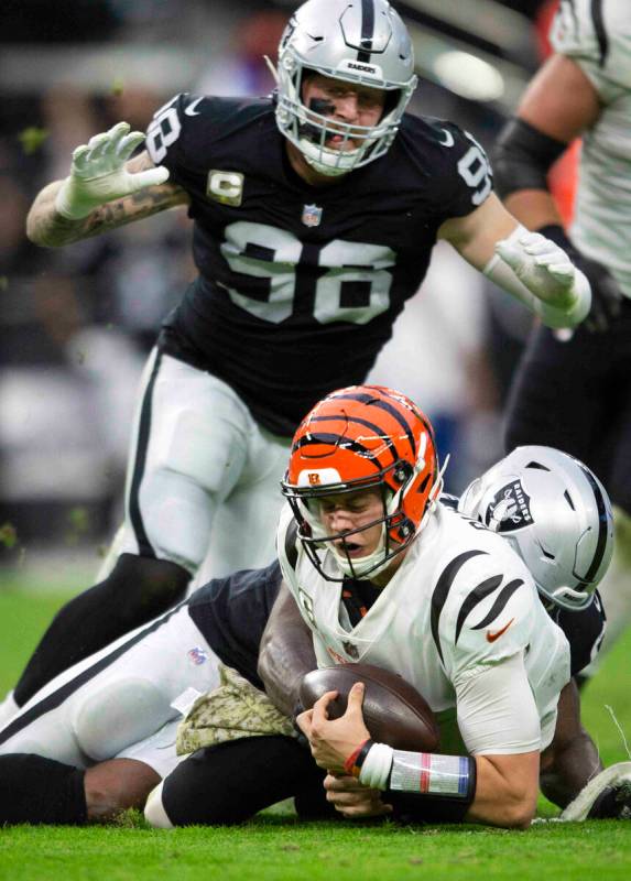 Raiders defensive end Yannick Ngakoue (91) sacks Cincinnati Bengals quarterback Joe Burrow (9) ...