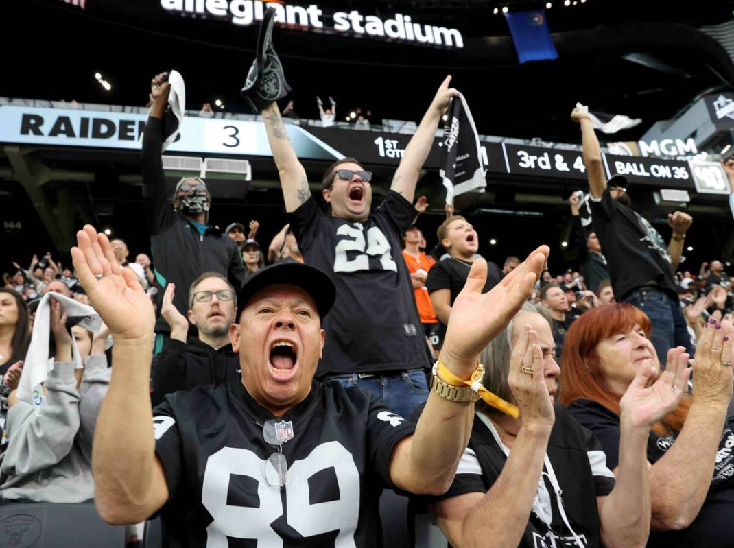 Raiders fans, including Jesus Fierros (89) and Sean Bryant (24) of Lake Elsinore, Calif. cheer ...