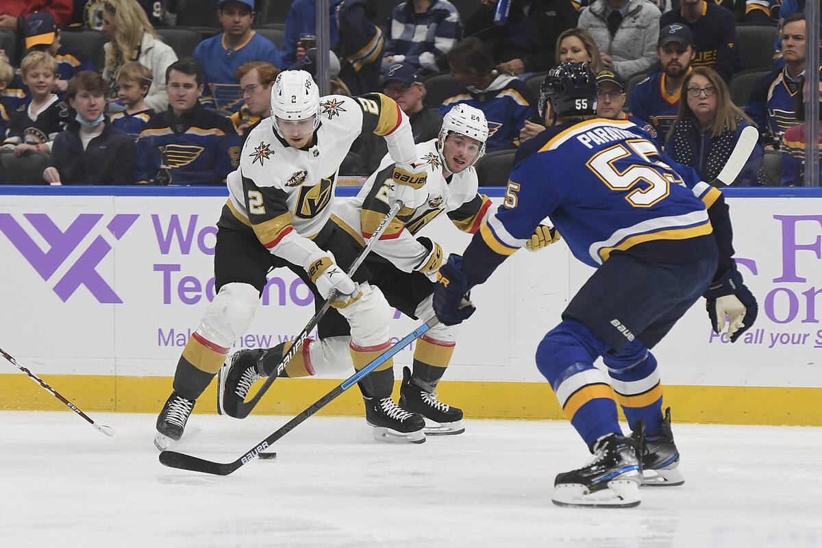 Vegas Golden Knights' Zach Whitecloud (2) works the puck as Vegas Golden Knights' Adam Brooks ( ...