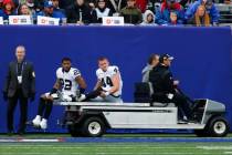 Las Vegas Raiders' Keisean Nixon (22) and Nick Kwiatkoski (44) are carted off the field during ...