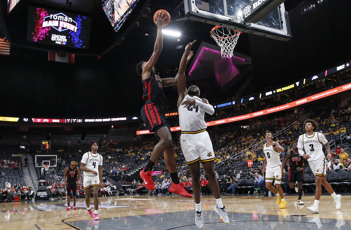 UNLV Rebels forward Royce Hamm Jr. (14) shoots over Wichita State Shockers forward Morris Udeze ...