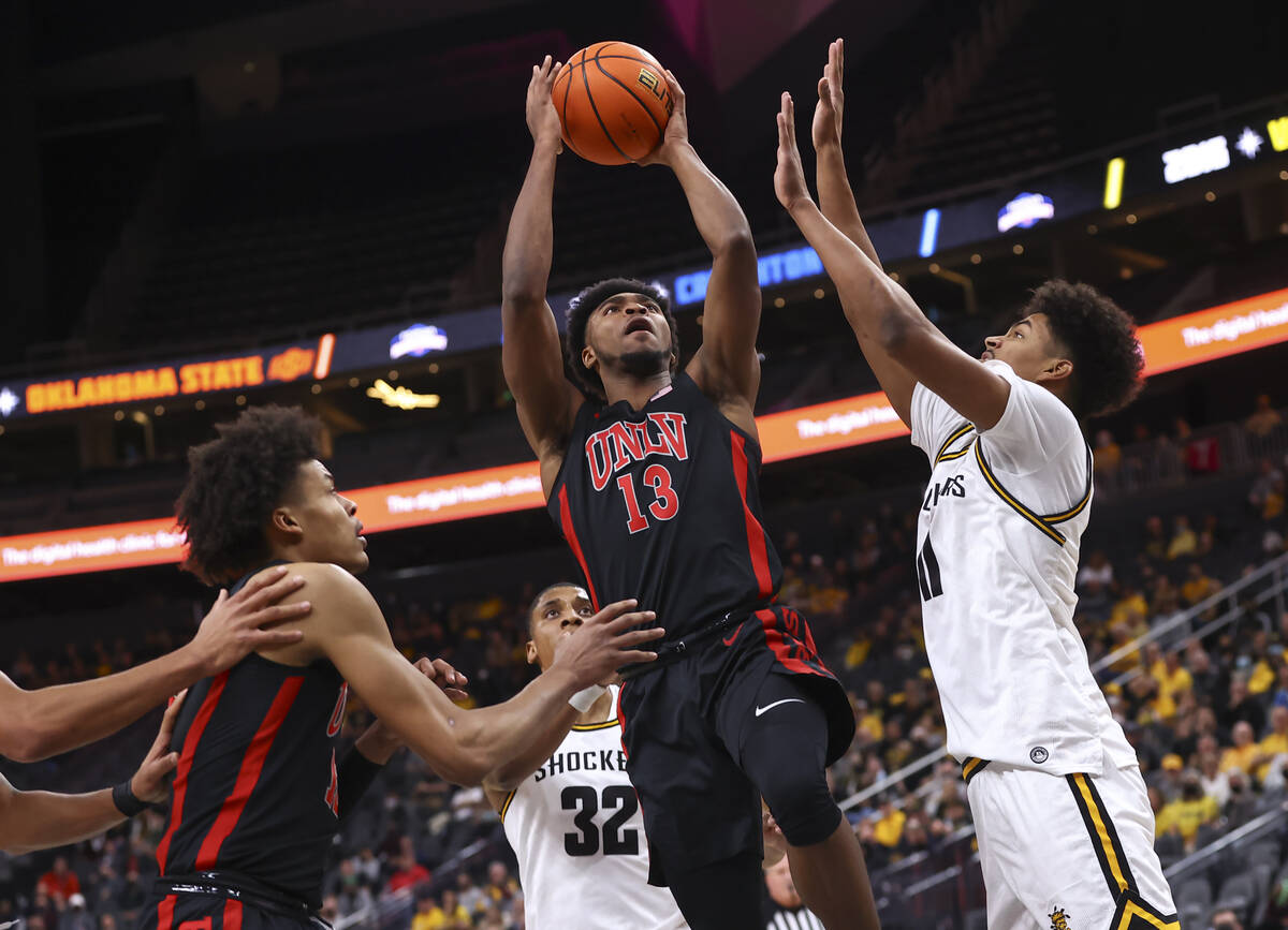 UNLV Rebels guard Bryce Hamilton (13) shoots under pressure from Wichita State Shockers forward ...
