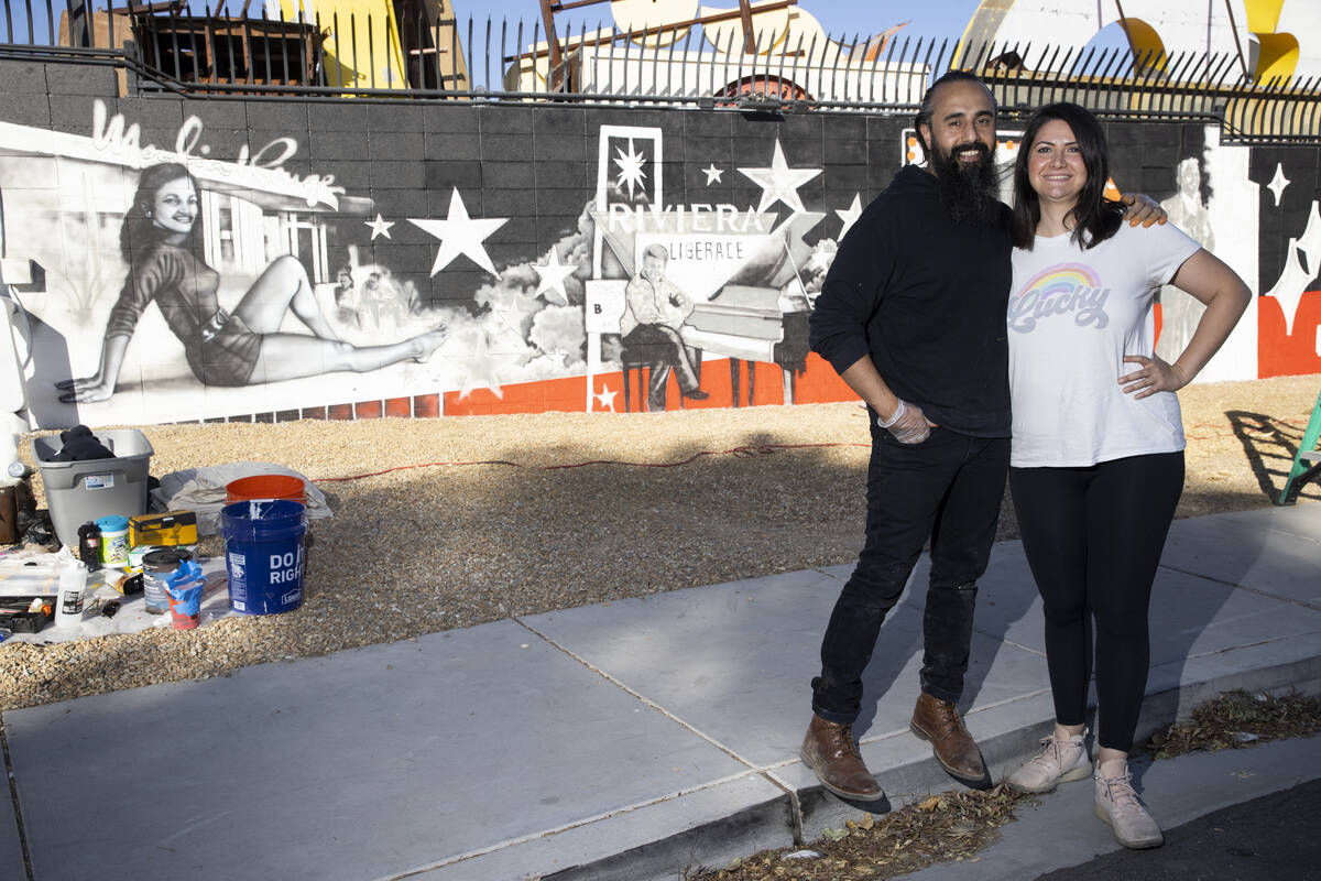 Ali Fathollahi, left, and wife Nanda Sharifpour pose for a portrait in front of a mural they ar ...