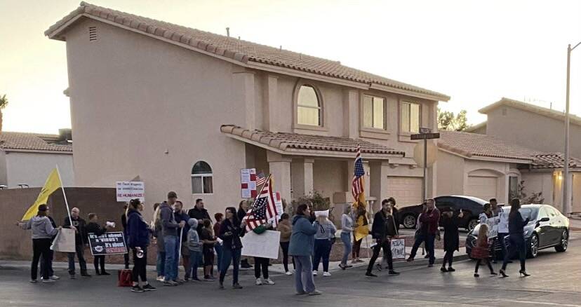 COVID-19 vaccine and mask mandate protesters gather around the Henderson home of Clark County S ...