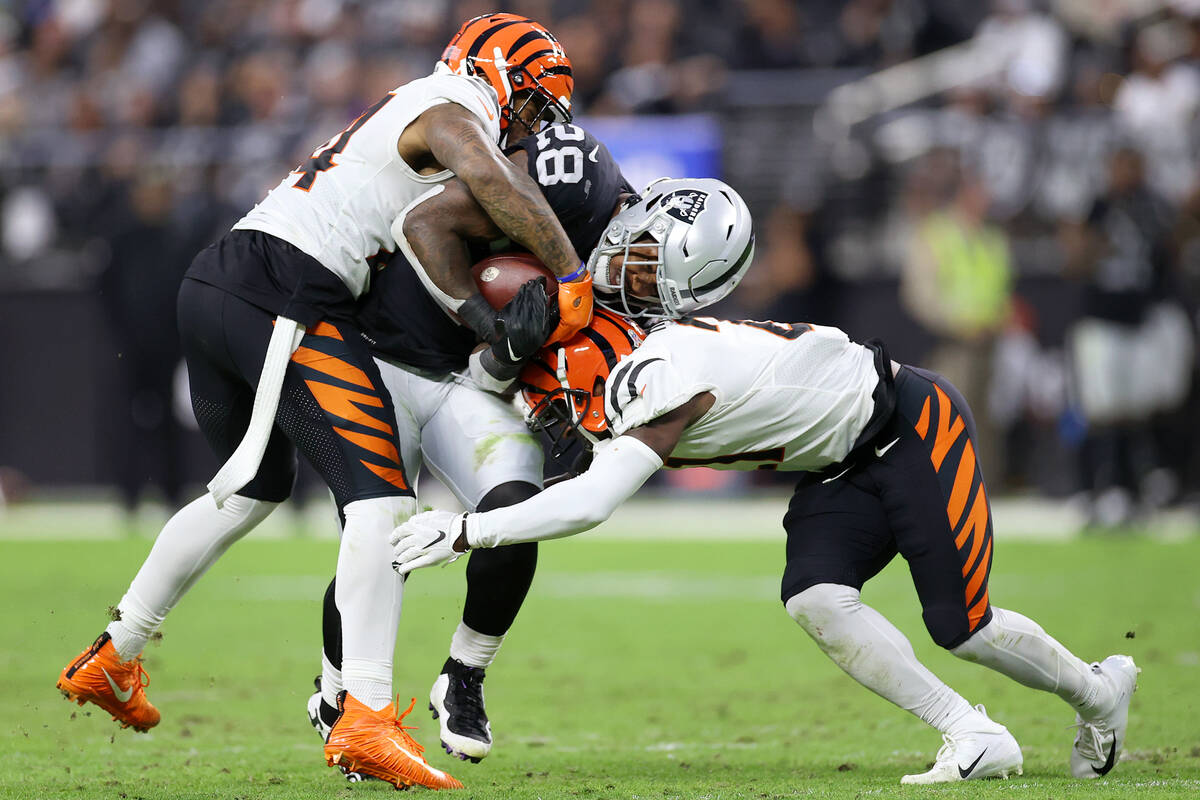 Cincinnati Bengals safety Vonn Bell (24) and cornerback Mike Hilton (21) tackle Raiders running ...