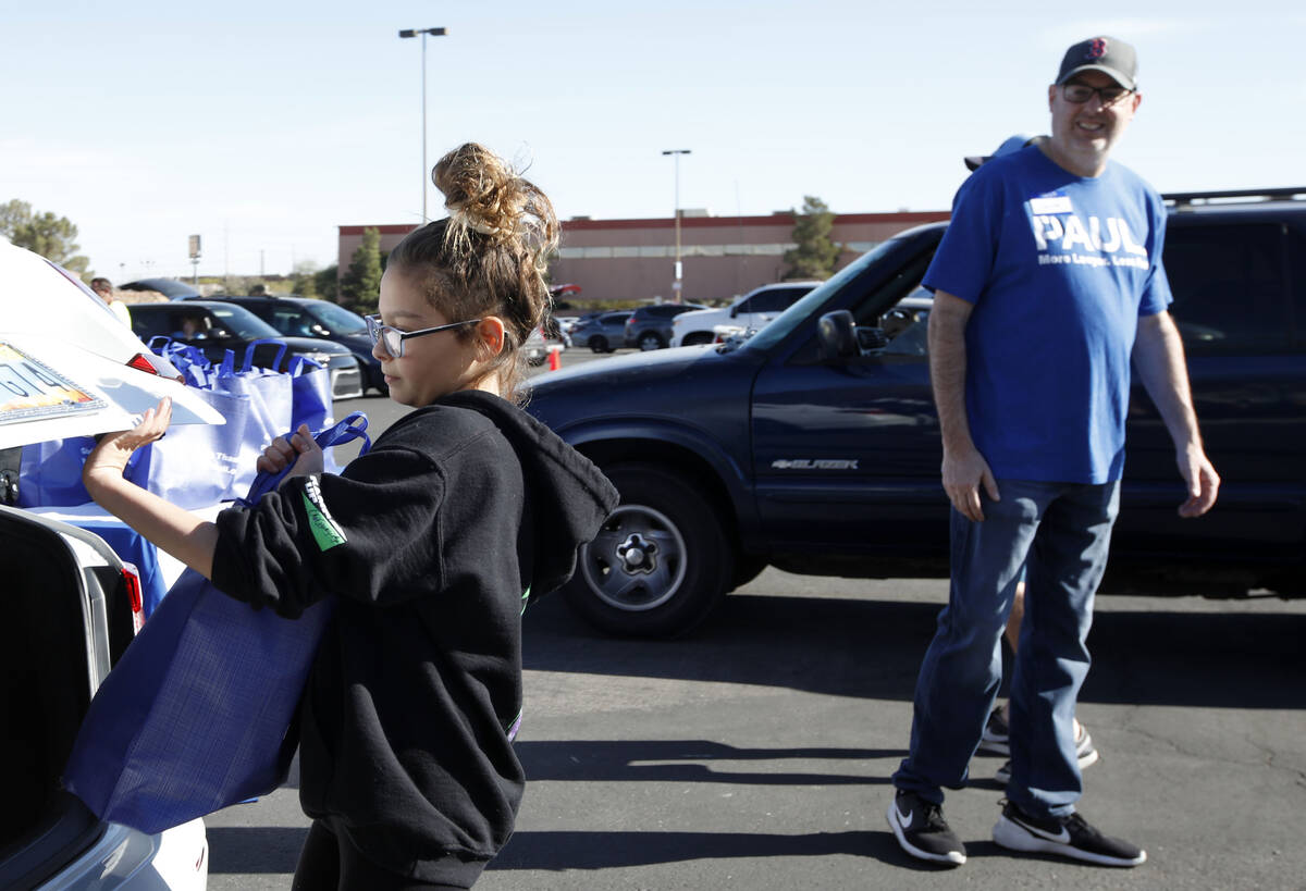 Gianna Marcolongo, 12, of Las Vegas helps to give away turkeys during Paul Powell's annual Than ...