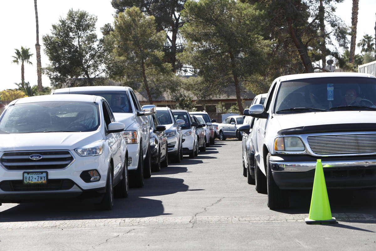 Cars line up to receive free turkeys during Paul Powell's annual Thanksgiving Turkey Giveaway a ...