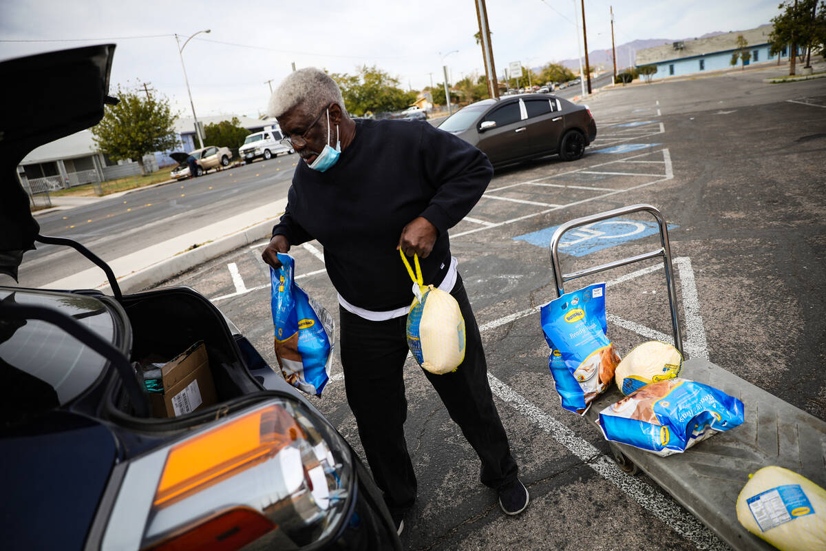 Volunteer Deacon Will Parks loads meals into a car to be delivered to senior citizens and peopl ...