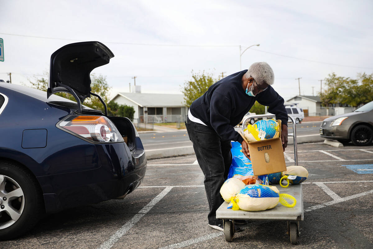 Volunteer Deacon Will Parks loads meals into a car to be delivered to senior citizens and peopl ...