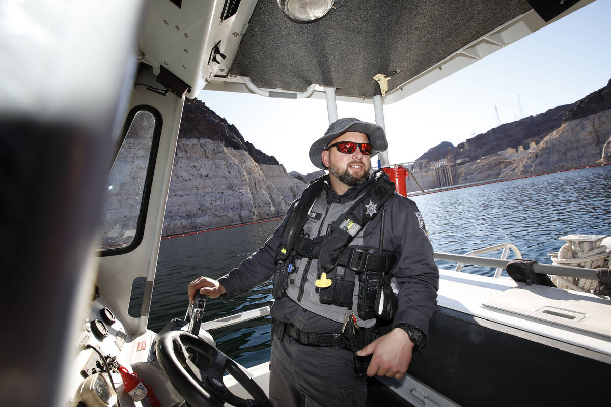 Sean Flynn, Nevada Department of Wildlife game warden, navigates a boat while he patrols Lake M ...