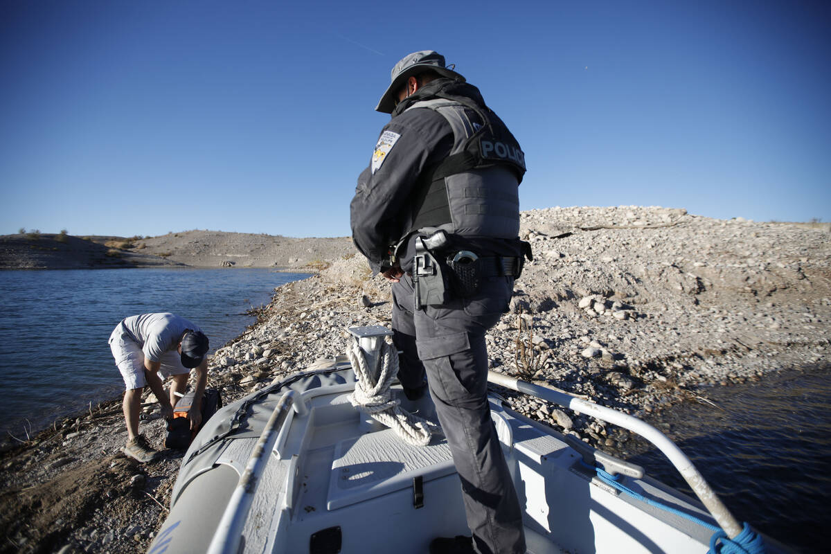 Sean Flynn, Nevada Department of Wildlife game warden, asks a fisherman to show his fishing lic ...