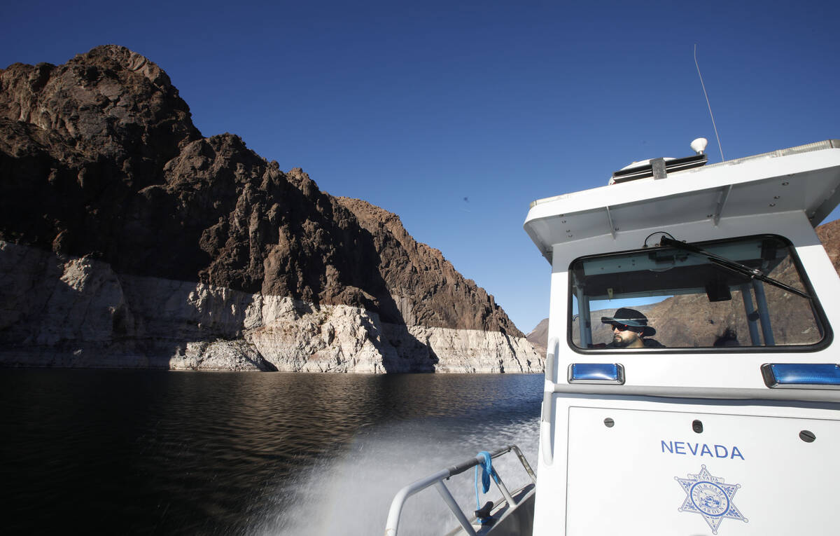 Sean Flynn, Nevada Department of Wildlife game warden, navigates a boat while he patrols Lake M ...