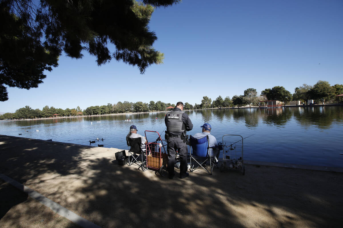 Sean Flynn, Nevada Department of Wildlife game warden, center, talks with fishermen while he pa ...