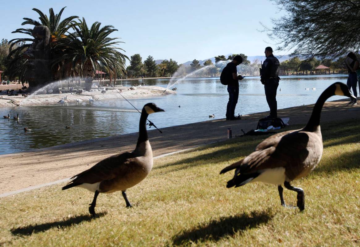 Sean Flynn, Nevada Department of Wildlife game warden, right, talks with a fisherman while he p ...