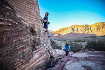 Alex King, of Denver, is belayed by his friend Johnny Acosta, also of Denver, as he climbs a ro ...