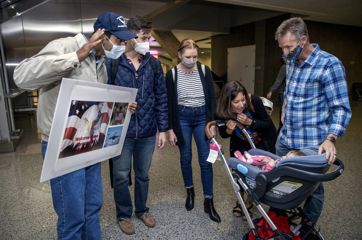 Afghan evacuee Benny, from left, pilot Christopher Hoffman, Hoffman's wife, Kristin, and parent ...
