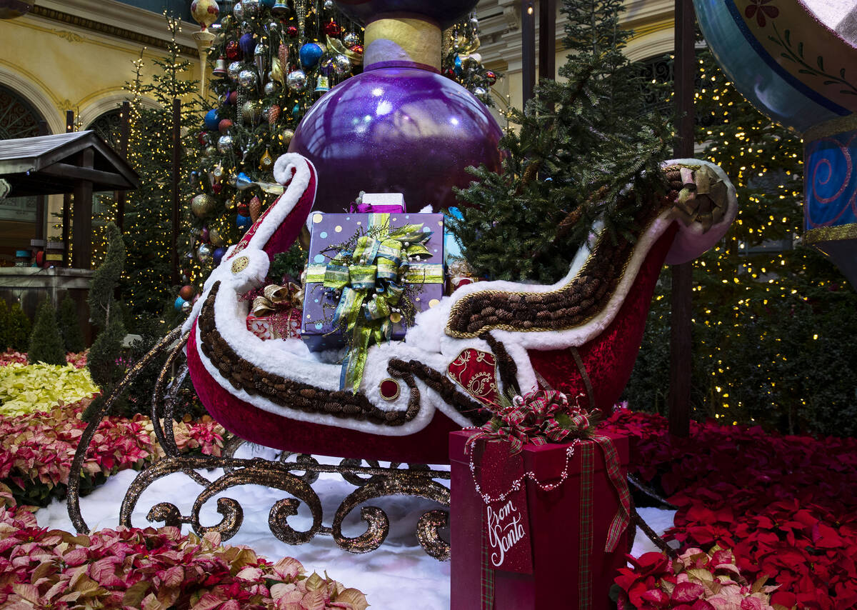 The Christmas Sleigh filled with gifts is displayed at tThe Bellagio Conservatory's holiday dis ...
