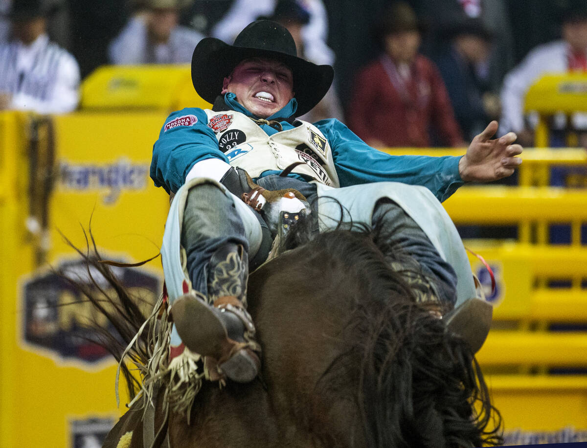 Richmond Champion of The Woodlands, Texas, digs deep in Bareback Riding during the tenth go ro ...