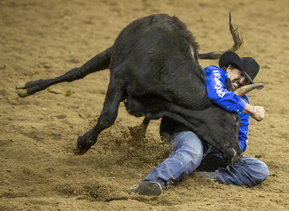 Tyler Pearson of Louisville, Miss., fights to take his steer down in Steer Wrestling during the ...