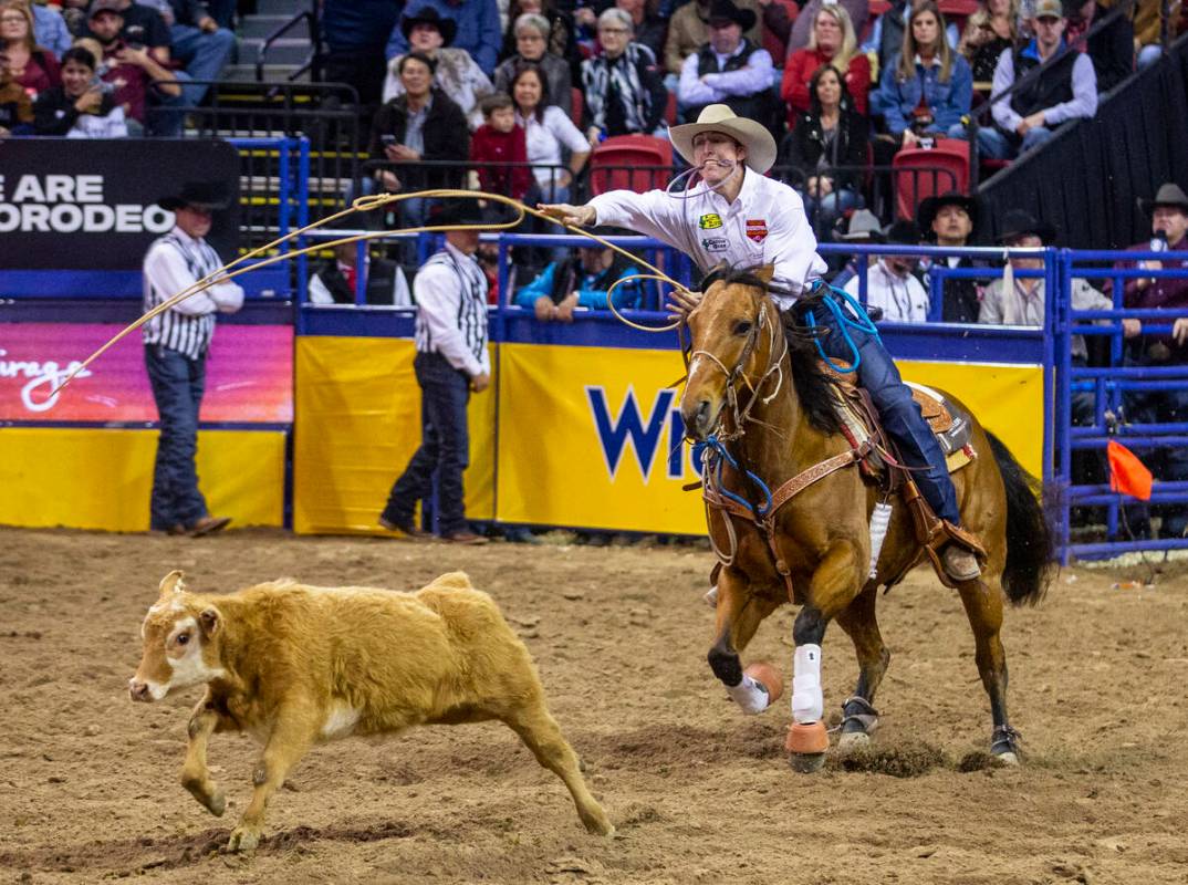 Taylor Santos of Creston, Calif., tosses his lasso in Tie-Down Roping at the tenth go round of ...