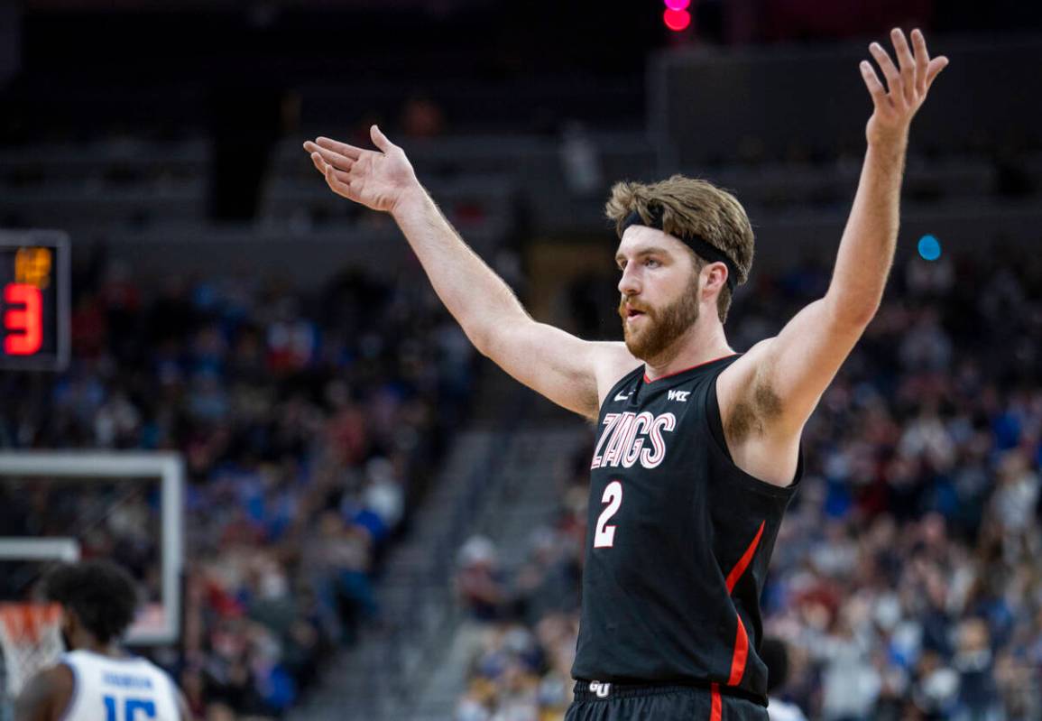 Gonzaga forward Drew Timme gestures to the crowd during the first half of the team's NCAA colle ...