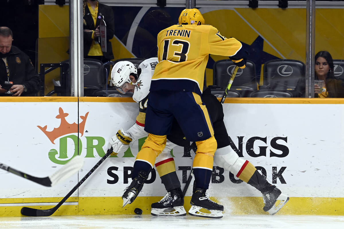 Nashville Predators center Yakov Trenin (13) tries to pin Vegas Golden Knights defenseman Nicol ...