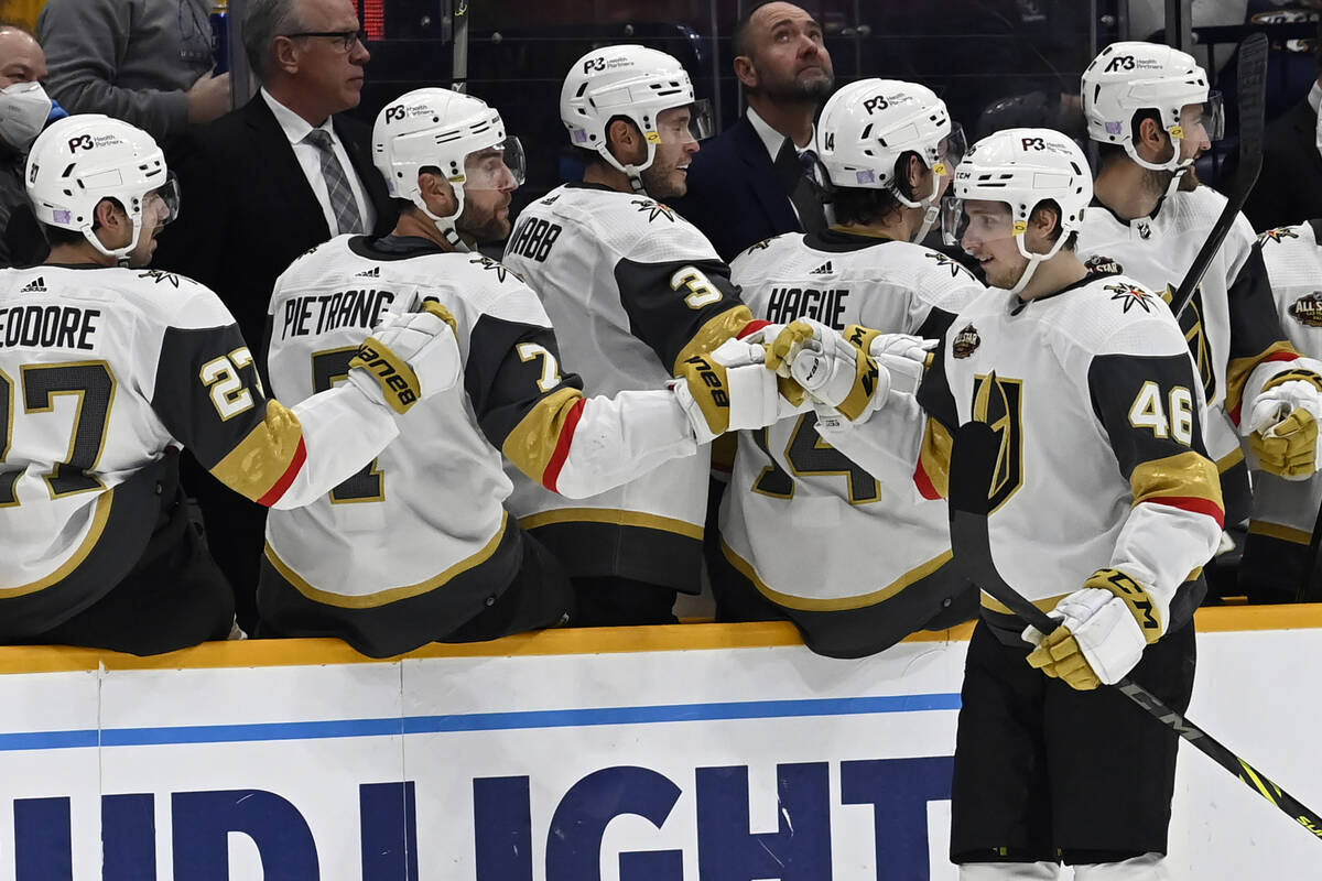 Vegas Golden Knights ring wing Jonas Rondbjerg (46) is congratulated after scoring a goal again ...
