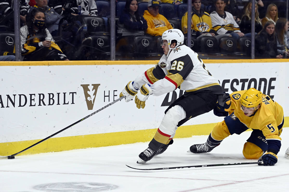 Vegas Golden Knights center Mattias Janmark (26) reaches for the puck in front of Nashville Pre ...