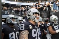 Raiders defensive end Maxx Crosby (98) waits to lead his team onto the field before the start o ...