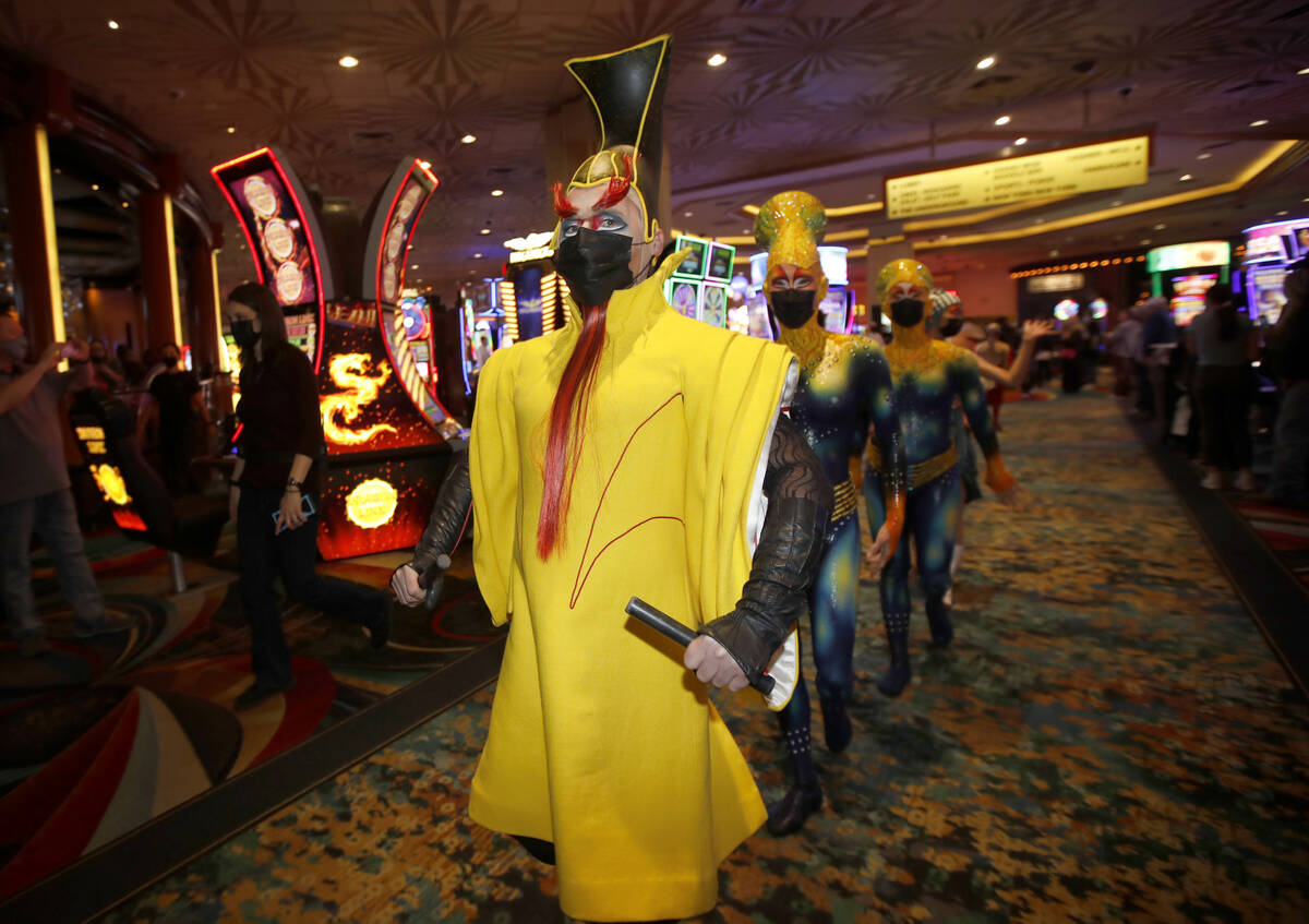 Cirque Du Soleil's KÀ artists walk to the theater after a pop-up performance in the lobby of M ...