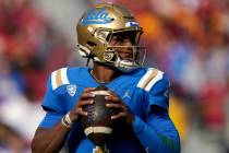 UCLA quarterback Dorian Thompson-Robinson gets set to pass during the first half of an NCAA col ...