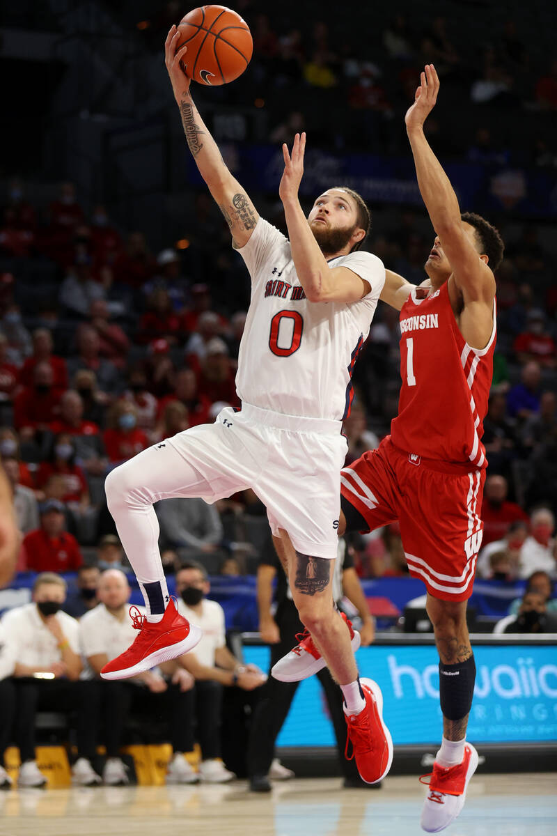 St. Mary's Gaels guard Logan Johnson (0) goes up for a shot against Wisconsin Badgers guard Joh ...