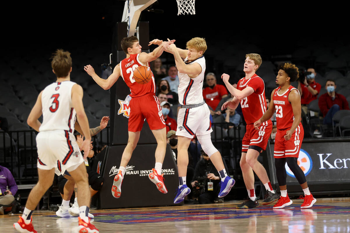 Wisconsin Badgers forward Ben Carlson (20) and St. Mary's Gaels forward Matthias Tass (11) figh ...
