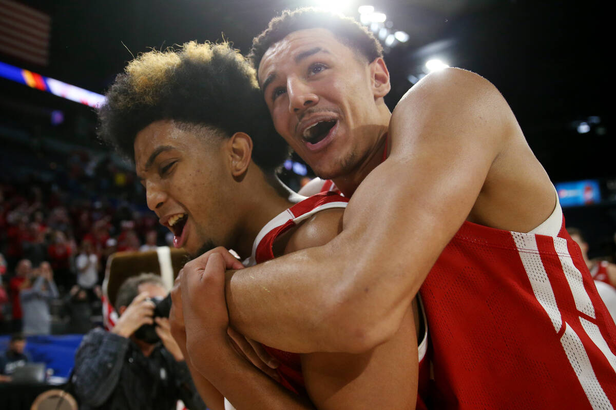 The Wisconsin Badgers including guard Chucky Hepburn (23) and guard Johnny Davis (1) celebrate ...