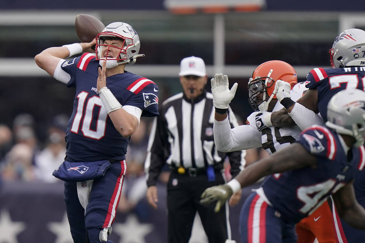New England Patriots quarterback Mac Jones (10) throws a pass during the first half of an NFL f ...