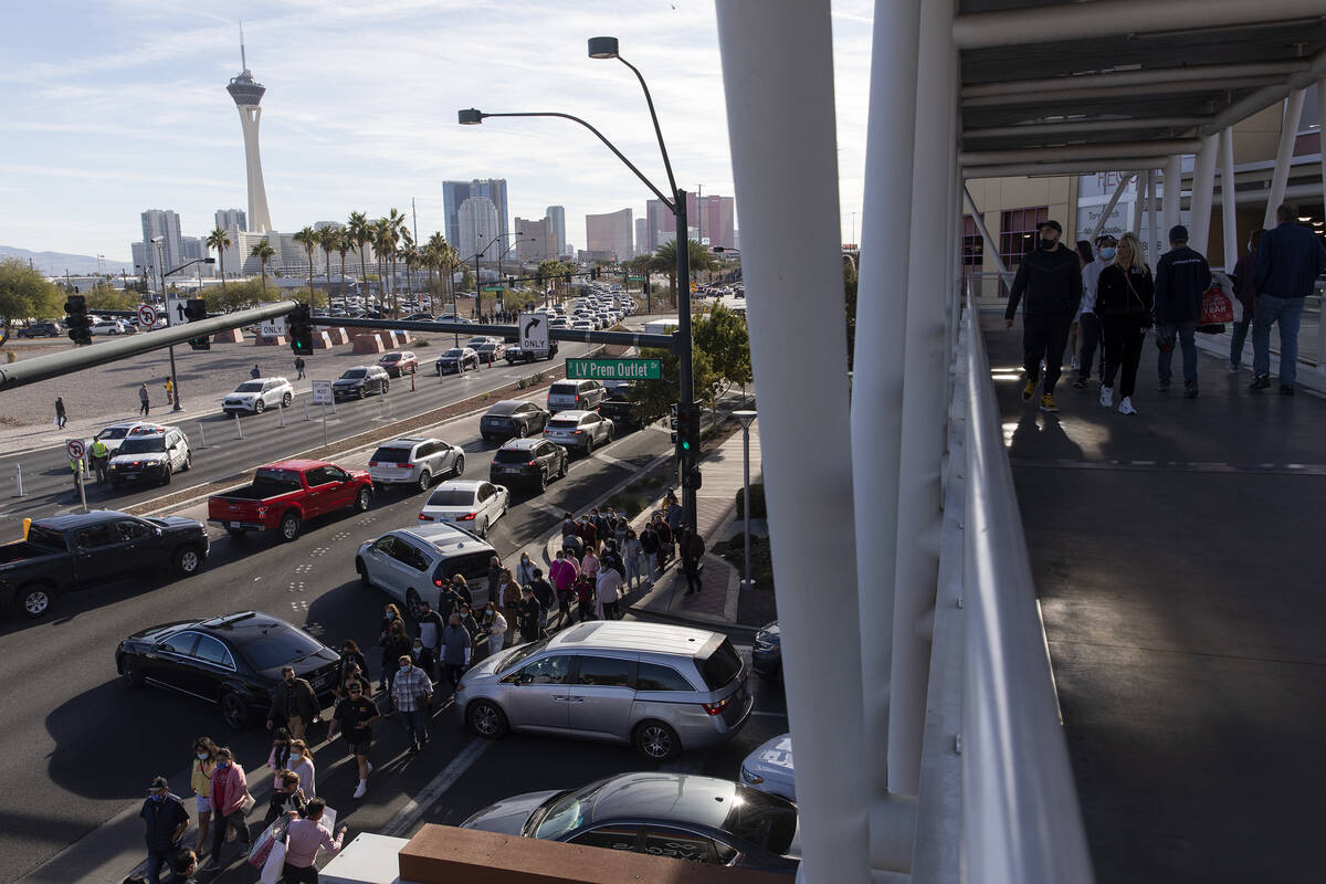 The Las Vegas Strip is seen in the background as traffic and pedestrians travel to and from the ...