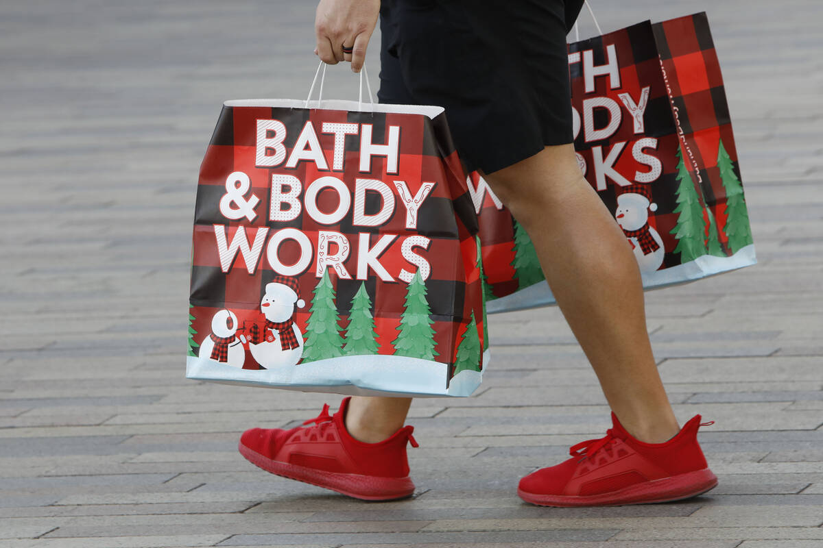 A Black Friday shopper carries bags at Downtown Summerlin, Friday, Nov. 26, 2021, in Las Vegas. ...