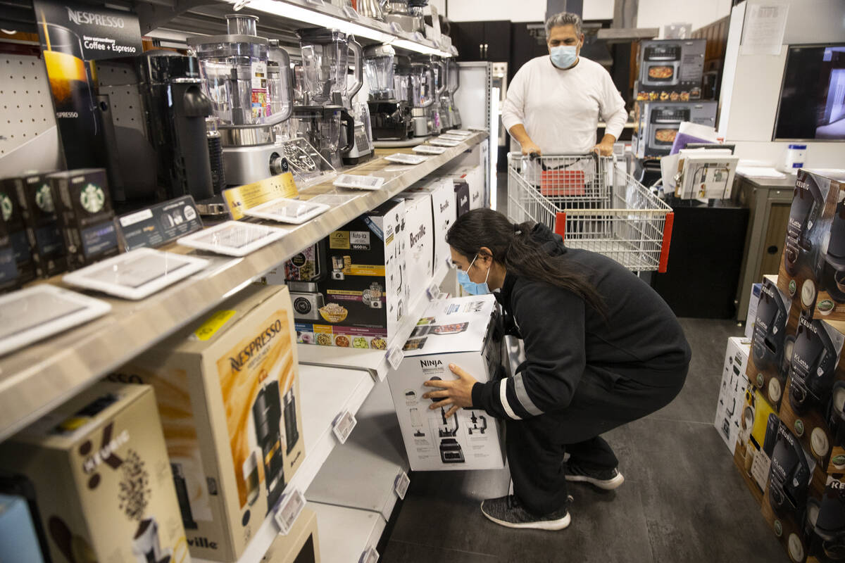 Christian Barrera picks up a blender as his father Jesse looks on during Black Friday shopping ...