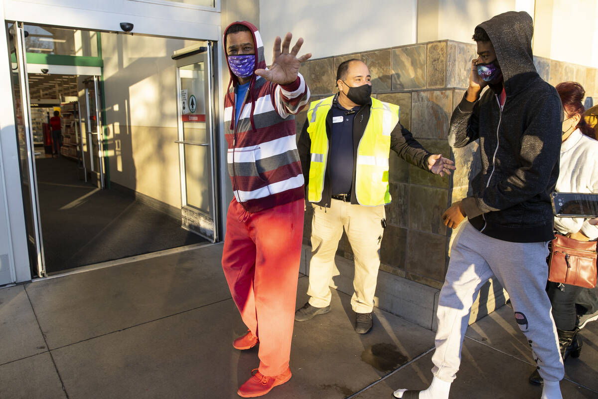 Deione Cox, left, and his son J.J., 16, are first to enter Target, 6480 Sky Pointe Drive, for B ...