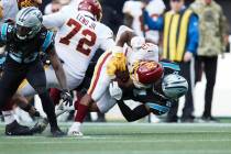 Washington Football Team running back Jaret Patterson (32) is tackled by Carolina Panthers safe ...