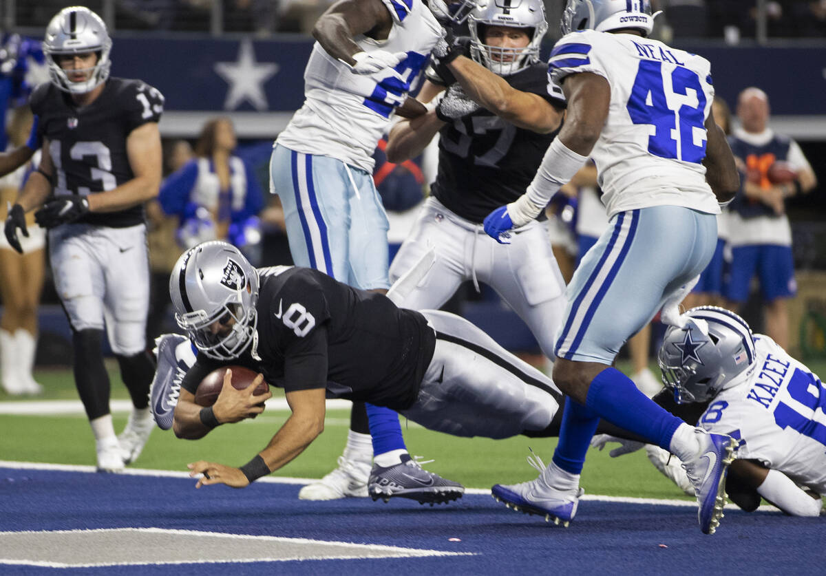 Raiders running back Josh Jacobs (28) leaps through a hole for a big run past Dallas Cowboys s ...