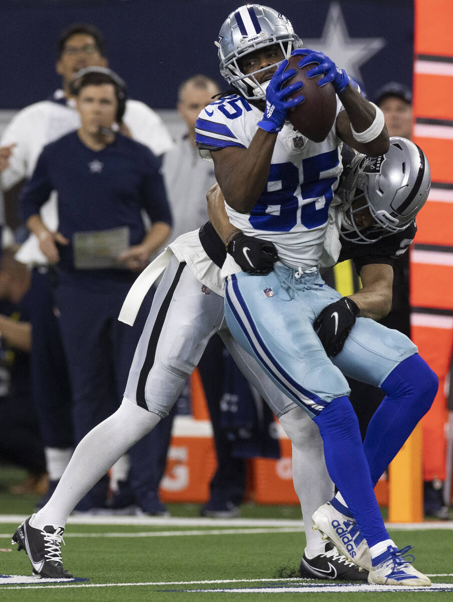 Dallas Cowboys wide receiver Noah Brown (85) makes a catch with Raiders safety Johnathan Abram ...