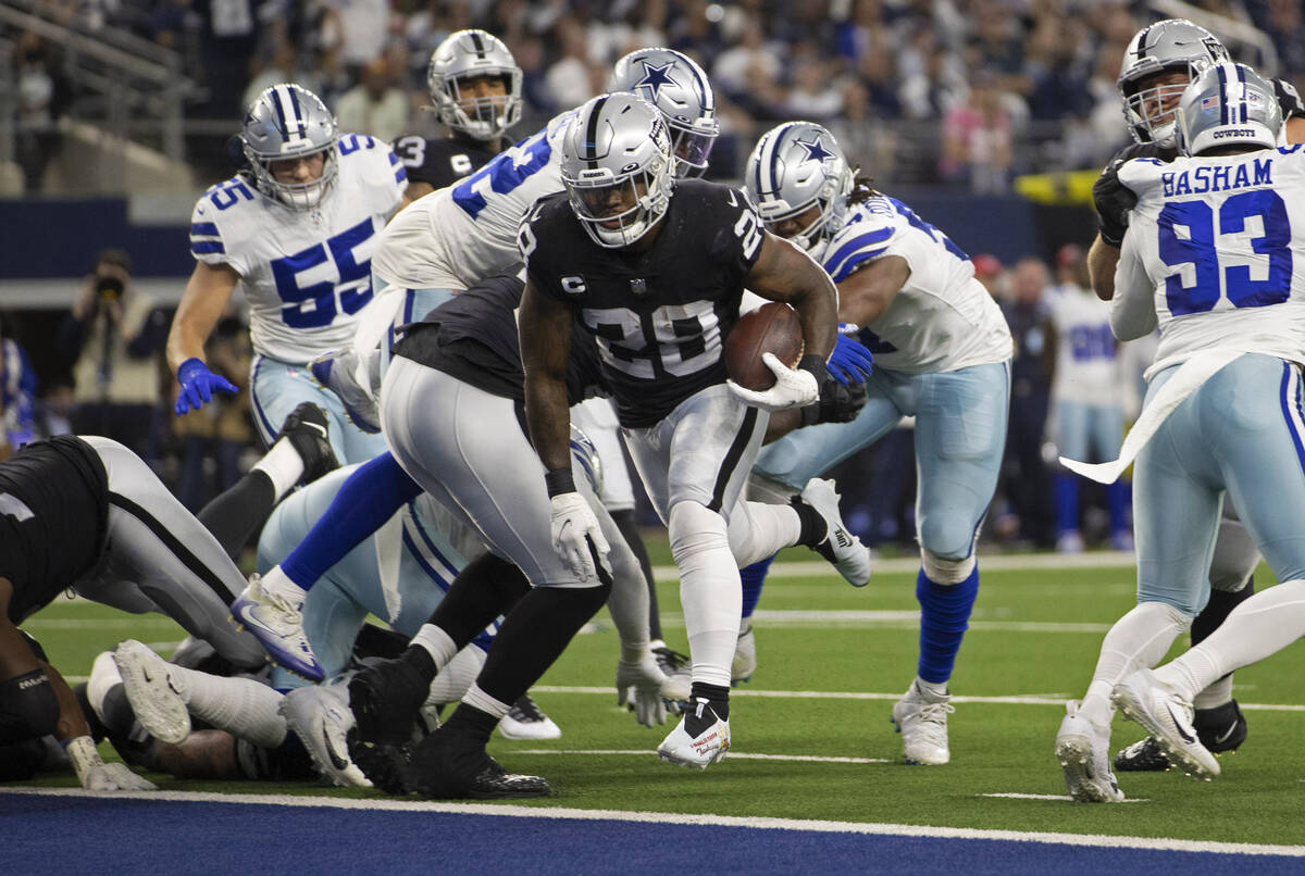 Raiders running back Josh Jacobs (28) leaps into the end zone in the first half during an NFL f ...