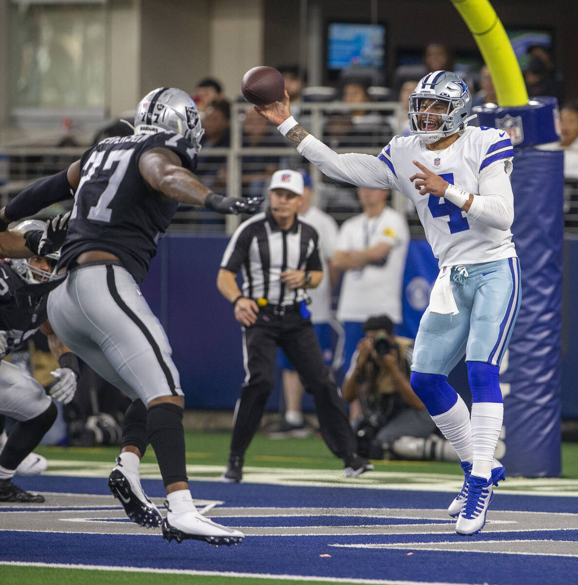 Dallas Cowboys quarterback Dak Prescott (4) makes a throw under pressure from Raiders defensive ...