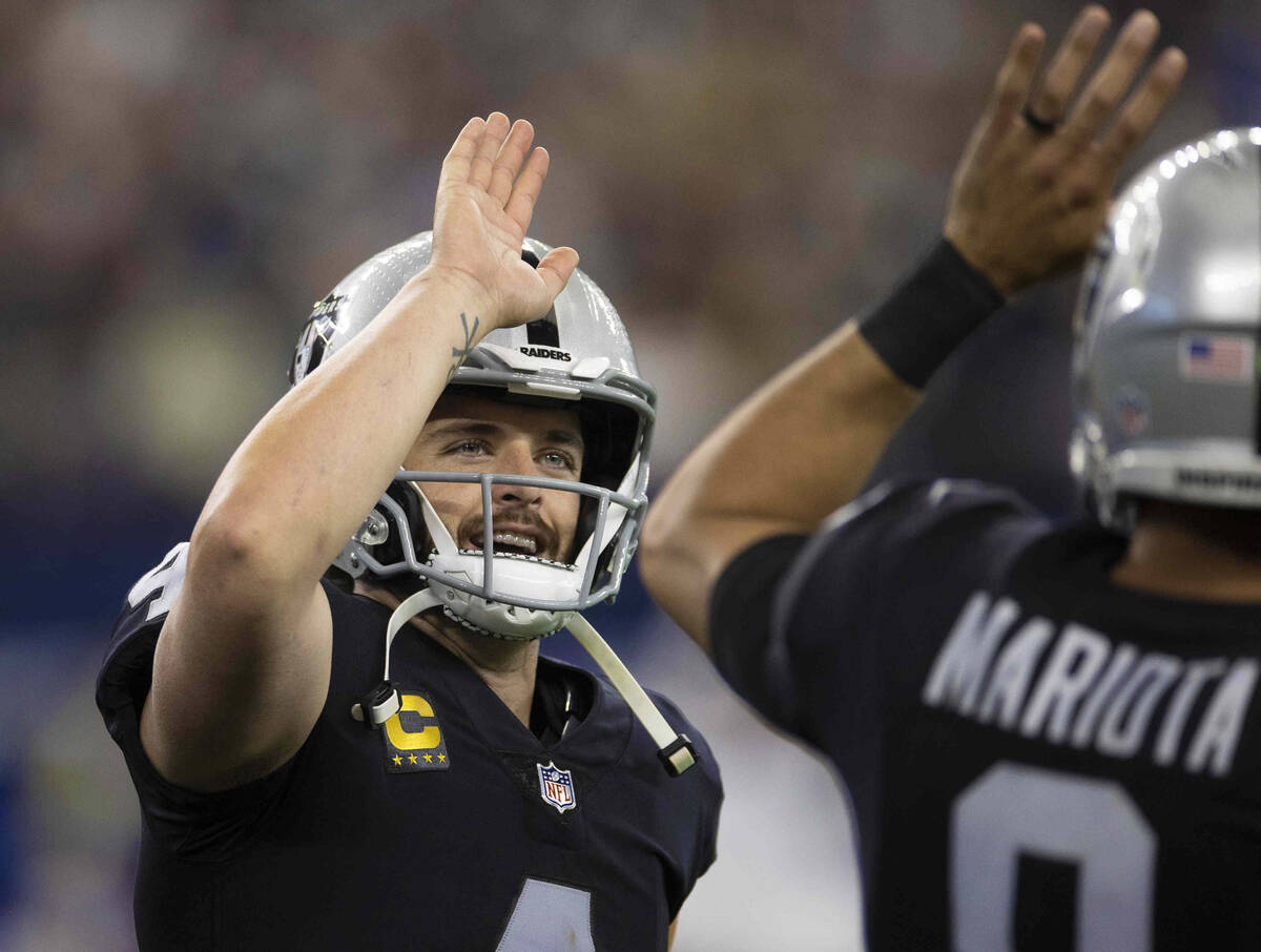Raiders quarterback Derek Carr (4) celebrates a first half touchdown with Raiders quarterback M ...