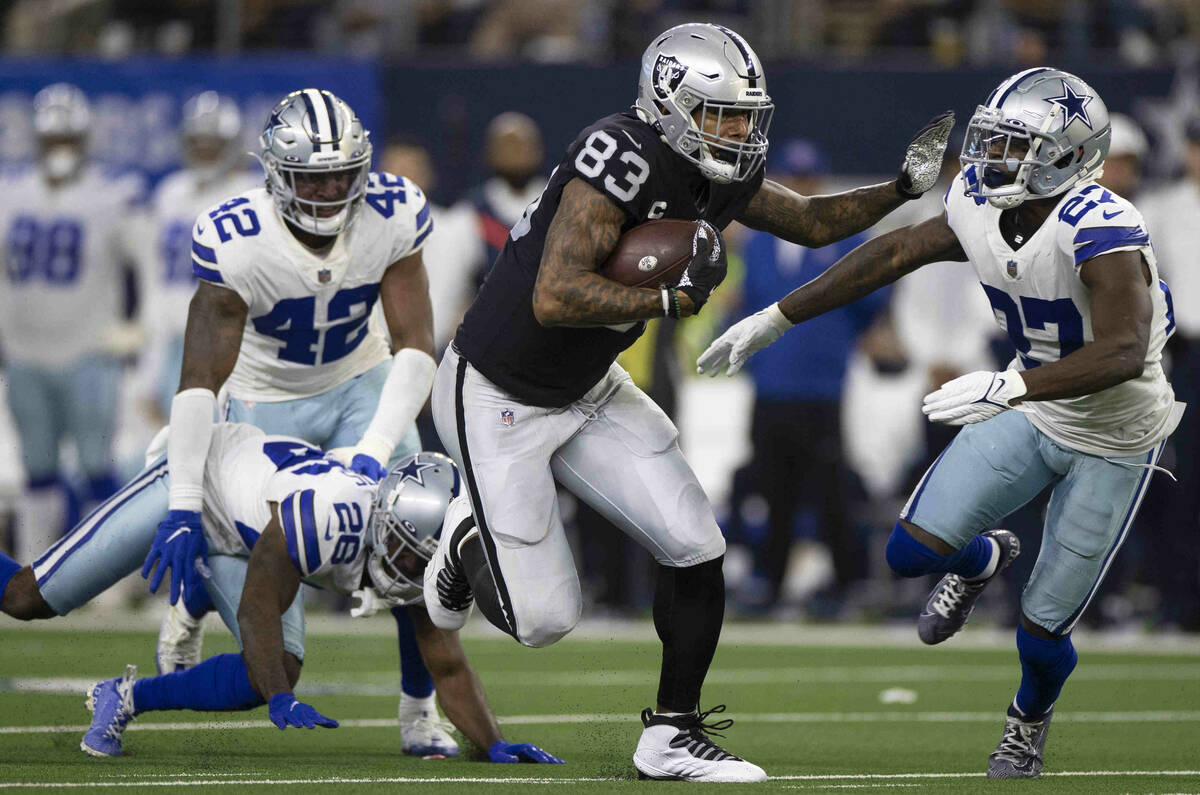Raiders tight end Darren Waller (83) makes a big catch and run past Dallas Cowboys safety Jayro ...
