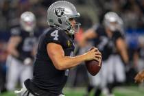 Raiders quarterback Derek Carr (4) runs with the football during the fourth quarter of an NFL f ...